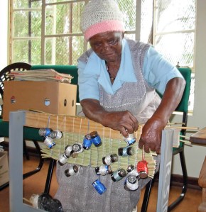 straw_mat_weaving The traditional art of straw mat weaving tales place alongside other gogos who are learning sewing, baking, gardening, knitting and beadwork.