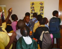 Some of the 50 kids in the Homework Program gather for a look at Susan’s goodbye message in a photo poster. 