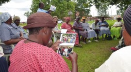 : Martina Makua examines photos closely 