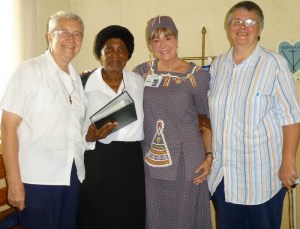 Presenting the photo album recording eight years of Grannies à Gogo fundraising for Sitabogogo, with Myriam Bryant, Cornelia Lukhele, Susan Fenner, Vicky Bryant.