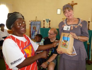 Paulina Ndlovu, Susan’s writing partner, presents her with gifts from the gogos as they say goodbye after four weeks.   