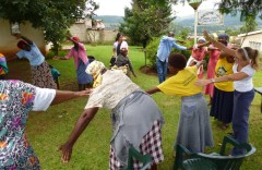 Physiotherapist Karen, far right, leads the gogos in warm up stretches. Interpreter Lucky is top, right of centre.