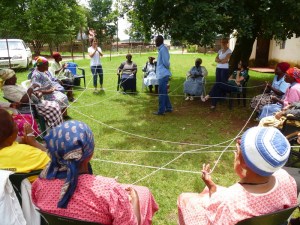 Occupational therapist Lizelle, top left, teaches a game that creates a web of kind words and unity